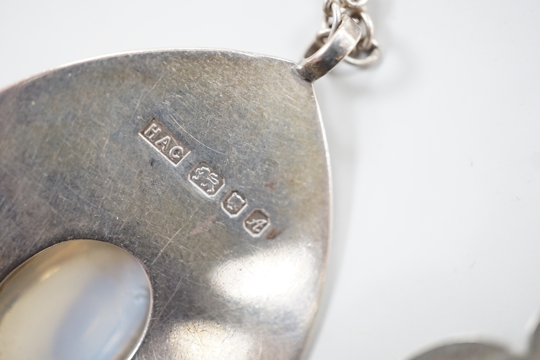 Three modern silver pendants by H.A. Crawshaw? including moonstone set pear shaped pendant, 53mm, all with chains.